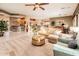 Large living room with a cozy seating area, an open floorplan, and lots of natural light at 22912 N San Ramon Ct, Sun City West, AZ 85375