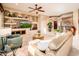 Inviting living room with custom built-ins, plush seating, and lots of natural light at 22912 N San Ramon Ct, Sun City West, AZ 85375