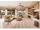 Cozy living room with built-in shelving and large windows offering beautiful backyard views at 22912 N San Ramon Ct, Sun City West, AZ 85375