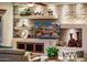 Stylish living room with modern decor and a TV displaying the outside living space with a fire pit at 22912 N San Ramon Ct, Sun City West, AZ 85375