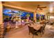 Spacious covered patio with multiple seating areas, including an outdoor dining space and cozy lounge furniture at 22912 N San Ramon Ct, Sun City West, AZ 85375