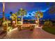 Inviting outdoor fire pit with comfortable seating, surrounded by swaying palm trees and manicured landscaping at 22912 N San Ramon Ct, Sun City West, AZ 85375