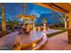 Elegant outdoor space with a dining set under an umbrella, overlooking a lush green lawn and golf course views at 22912 N San Ramon Ct, Sun City West, AZ 85375