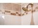 Detailed shower showcasing custom stone-patterned tile work and a modern shower head fixture at 22912 N San Ramon Ct, Sun City West, AZ 85375