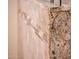 Detailed shower showcasing custom stone-patterned tile work and a granite trim at 22912 N San Ramon Ct, Sun City West, AZ 85375