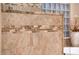 Detailed shower showcasing custom stone-patterned tile work at 22912 N San Ramon Ct, Sun City West, AZ 85375