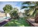 Backyard oasis featuring a lush garden, bridge, and a view of the home's pool and patio area at 2533 E Flower St, Phoenix, AZ 85016