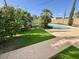 Large backyard with refreshing pool, mature trees, and well-maintained artificial turf at 2533 E Flower St, Phoenix, AZ 85016