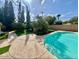 Inviting backyard featuring a refreshing pool, lush greenery, and a peaceful setting at 2533 E Flower St, Phoenix, AZ 85016