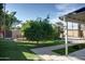 Spacious backyard features mature landscaping, green lawn, and covered patio area at 2533 E Flower St, Phoenix, AZ 85016