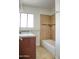 Well lit bathroom featuring a granite countertop, framed mirror, and a tiled shower and bathtub enclosure at 2533 E Flower St, Phoenix, AZ 85016