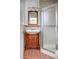 Bathroom featuring a tiled walk-in shower and a vanity at 2533 E Flower St, Phoenix, AZ 85016