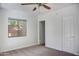 Bedroom featuring a ceiling fan, plush carpet, and a window, creating a comfortable and inviting atmosphere at 2533 E Flower St, Phoenix, AZ 85016