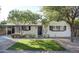 Charming home featuring lush landscaping, artificial grass, and a cozy covered entrance at 2533 E Flower St, Phoenix, AZ 85016