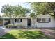 Charming home with well-maintained lawn, mature trees and white painted brick at 2533 E Flower St, Phoenix, AZ 85016