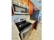 Updated kitchen with stainless steel appliances, including a range, microwave, and refrigerator at 2533 E Flower St, Phoenix, AZ 85016
