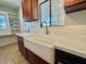 Charming kitchen featuring a farmhouse sink, stainless steel faucet, and ample counter space at 2533 E Flower St, Phoenix, AZ 85016