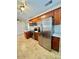 Well-lit kitchen featuring stainless steel appliances, wood cabinets, and tile flooring at 2533 E Flower St, Phoenix, AZ 85016