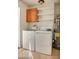 Functional laundry room equipped with storage cabinets, washer, and dryer at 2533 E Flower St, Phoenix, AZ 85016