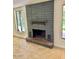 Living room features a decorative brick fireplace and tile floors at 2533 E Flower St, Phoenix, AZ 85016
