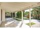 Inviting covered patio with tiled flooring overlooking a lush landscaped backyard with mature trees at 2533 E Flower St, Phoenix, AZ 85016