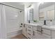 A well-lit bathroom with dual sinks and a shower-tub combination at 2754 S Sulley Dr # 103, Gilbert, AZ 85295