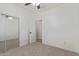 Bedroom featuring neutral carpet, walk-in closet with mirrored doors, and an open doorway at 2754 S Sulley Dr # 103, Gilbert, AZ 85295