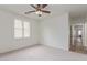 A spacious bedroom with a ceiling fan, neutral carpet, and bright natural light at 2754 S Sulley Dr # 103, Gilbert, AZ 85295