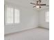 A bright, spacious bedroom with neutral carpet and a ceiling fan at 2754 S Sulley Dr # 103, Gilbert, AZ 85295