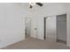 Bedroom with an open doorway to bathroom and mirrored closet doors at 2754 S Sulley Dr # 103, Gilbert, AZ 85295