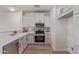 Modern kitchen with stainless appliances, white cabinets, and quartz countertops at 2754 S Sulley Dr # 103, Gilbert, AZ 85295