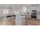 An open concept kitchen with white cabinets and stainless steel appliances at 2754 S Sulley Dr # 103, Gilbert, AZ 85295