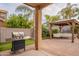 Beautiful backyard with a built-in BBQ grill and a covered seating area for outdoor relaxation at 2939 W Sunshine Butte Dr, San Tan Valley, AZ 85144