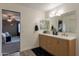 Bathroom with a double sink vanity, modern fixtures, and decorative mirrors providing a bright and stylish space at 2939 W Sunshine Butte Dr, San Tan Valley, AZ 85144