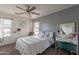 Cozy bedroom with a ceiling fan, vanity area, and comfortable bedding creating a relaxing atmosphere at 2939 W Sunshine Butte Dr, San Tan Valley, AZ 85144