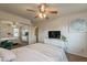Bright bedroom features a comfy bed, mounted TV, and plenty of storage with views reflected in the sliding mirror closet at 2939 W Sunshine Butte Dr, San Tan Valley, AZ 85144