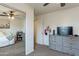 Clean and organized bedroom with a mirrored closet and a gray dresser with a television at 2939 W Sunshine Butte Dr, San Tan Valley, AZ 85144