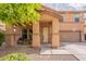 Inviting home featuring a charming front porch, two-car garage, and low maintenance desert landscaping at 2939 W Sunshine Butte Dr, San Tan Valley, AZ 85144