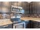 Close-up of modern kitchen with stainless steel appliances and a stylish tile backsplash at 2939 W Sunshine Butte Dr, San Tan Valley, AZ 85144