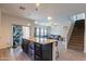Open concept kitchen with island seating and view to the pool and stairs at 2939 W Sunshine Butte Dr, San Tan Valley, AZ 85144