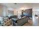 Open-concept living area features modern decor, wood-look floors, and abundant natural light at 2939 W Sunshine Butte Dr, San Tan Valley, AZ 85144
