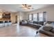 Open concept living room with view to the kitchen, breakfast bar seating, and a cozy sectional sofa at 2939 W Sunshine Butte Dr, San Tan Valley, AZ 85144