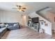 Comfortable living room with a ceiling fan, wood floors, entertainment center, and cozy grey couch at 2939 W Sunshine Butte Dr, San Tan Valley, AZ 85144