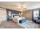 Bright main bedroom boasting a statement wall, designer bed, and comfortable seating area at 2939 W Sunshine Butte Dr, San Tan Valley, AZ 85144