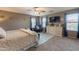 Spacious main bedroom with TV, dresser, accent chair, and two windows with bright natural light at 2939 W Sunshine Butte Dr, San Tan Valley, AZ 85144