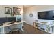 Well-lit home office setup with a modern desk, multiple monitors, and decorative wall art enhancing productivity at 2939 W Sunshine Butte Dr, San Tan Valley, AZ 85144