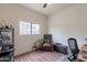 Cozy office features a leather chair, colorful rug, and ample natural light from the window at 2939 W Sunshine Butte Dr, San Tan Valley, AZ 85144