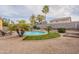 Lovely pool area with seating, surrounded by desert landscaping and mature trees at 2939 W Sunshine Butte Dr, San Tan Valley, AZ 85144