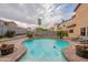 Sparkling pool with water features, offering a refreshing backyard oasis for hot days at 2939 W Sunshine Butte Dr, San Tan Valley, AZ 85144