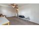 A spare room provides ceiling fan, pilates equipment and a view to the hallway and stairway at 2939 W Sunshine Butte Dr, San Tan Valley, AZ 85144